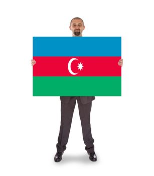 Smiling businessman holding a big card, flag of Azerbaijan