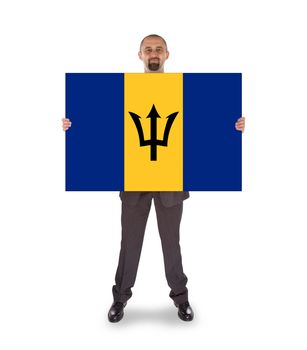 Smiling businessman holding a big card, flag of Barbados