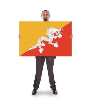 Smiling businessman holding a big card, flag of Bhutan