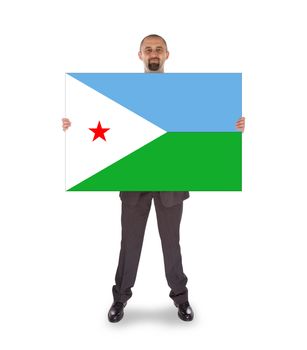 Smiling businessman holding a big card, flag of Djibouti