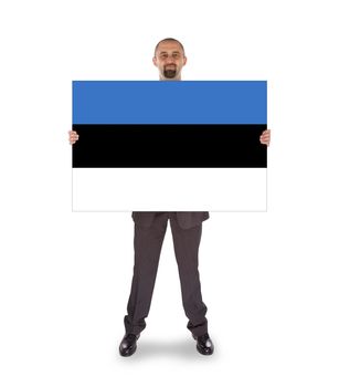 Smiling businessman holding a big card, flag of Estonia