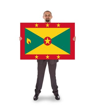 Smiling businessman holding a big card, flag of Grenada