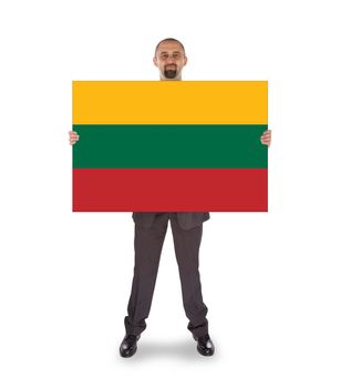 Smiling businessman holding a big card, flag of Lithuania