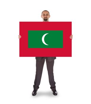 Smiling businessman holding a big card, flag of Maldives