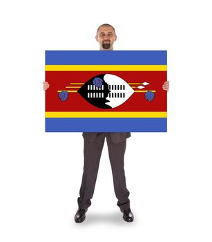 Smiling businessman holding a big card, flag of Swaziland