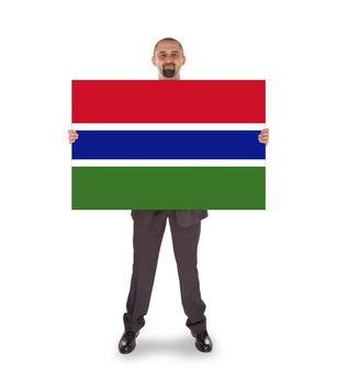 Smiling businessman holding a big card, flag of The Gambia