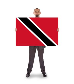Smiling businessman holding a big card, flag of Trinidad and Tobago