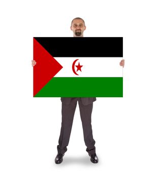 Smiling businessman holding a big card, flag of Western Sahara