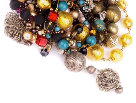 Heap of Jewelry with Gold Bracelets, Ruby Necklace, Pearl and Gem Beads isolated on white background. Top View