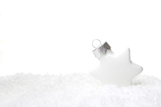 white christmas bauble as christmas star on snow 