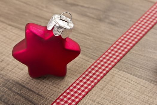 Christmas decoration with wood background, Christmas balls as star red with ribbon 