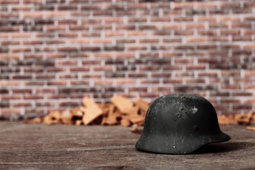 an old helmet abandoned and brick wall