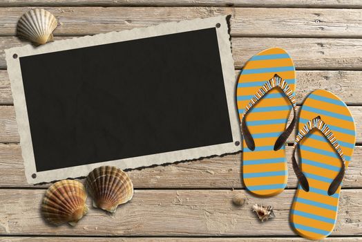 Aged photo frame with seashells on beach, flip flops sandals on wooden floor with sand