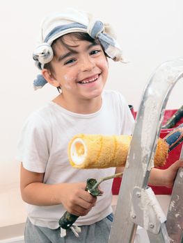 caucasian boy painting and smiling
