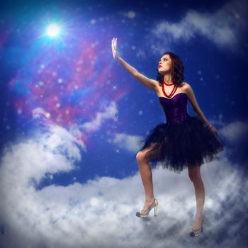 Young woman reaching for a glowing star, around abstract background