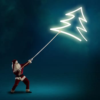 Santa Claus pulls a glowing symbol of the Christmas tree with a rope