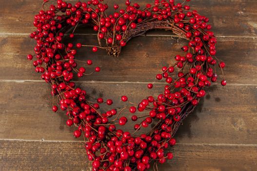A heart shaped Christmas wreath of red berries