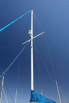 Mast of a modern yacht against blue sky