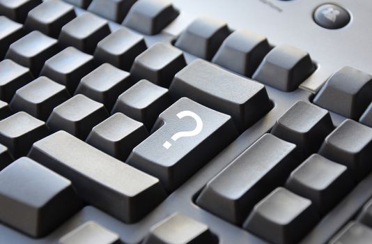 White question mark on grey keyboard
