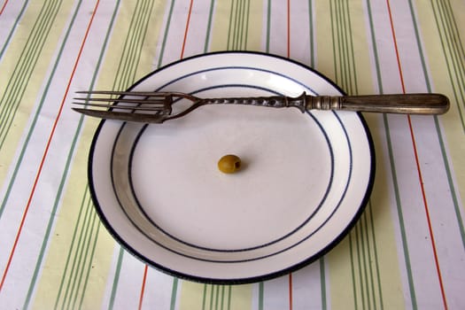big old fork with knife on dish with olive