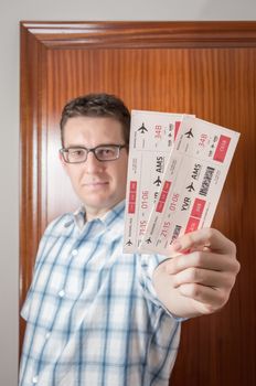 Portrait of happy man showing boarding pass ready to his holidays travel