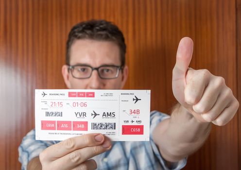 Portrait of happy man showing boarding pass ready to his holidays travel