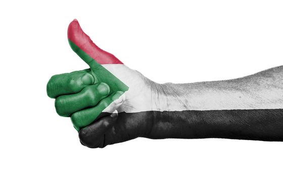 Old woman giving the thumbs up sign, isolated, flag of Sudan