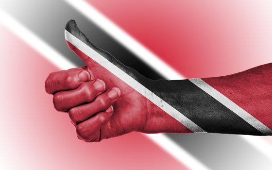 Old woman giving the thumbs up sign, isolated, flag of Trinidad and Tobago