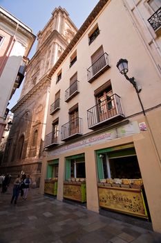 Corner of romanillas square with belltower of Cathedral, Granada, Spain