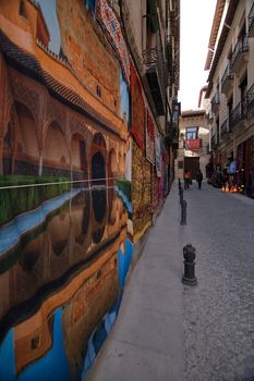 Fabrics and tapestries hanging on a wall near to Carrera del Darro, Granada, Spain