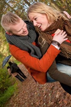 Happy young couple is having a nice time in october