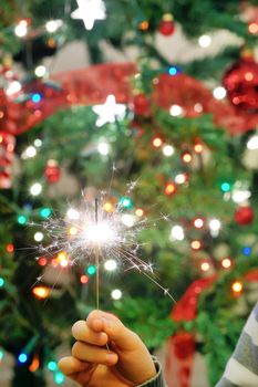 Christmas party sparkler on background of lights