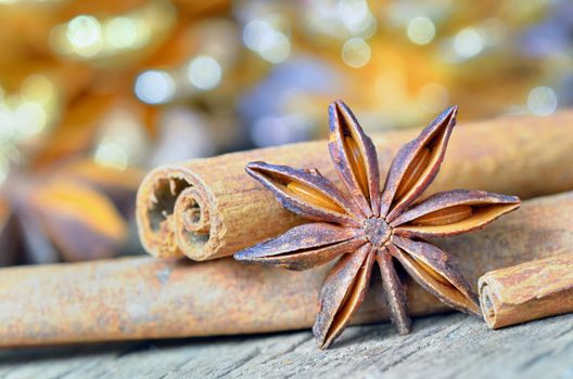 extremely closeup view of anise star and cinnamon sticks, on wooden table