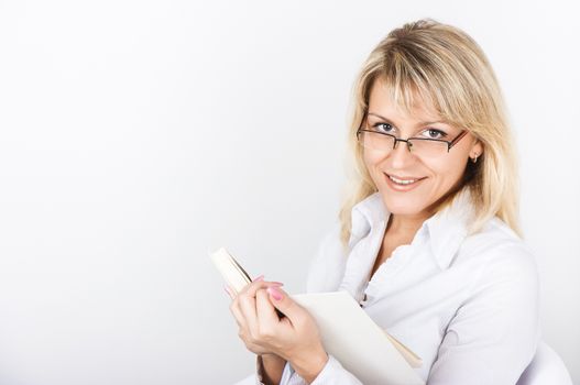 Cute blonde in glasses holding White Book