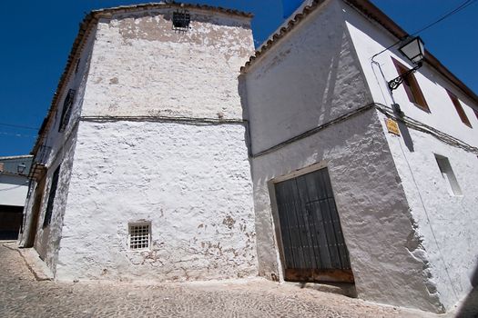 Corner of Sabiote with a wooden door and little window, Jaen, Spain