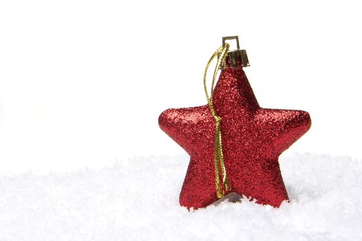 christmas, red christmas bauble as christmas star on snow 