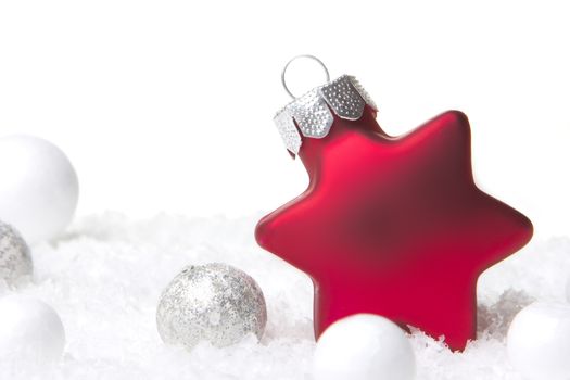 christmas, red christmas bauble as christmas star on snow with decoration silver 
