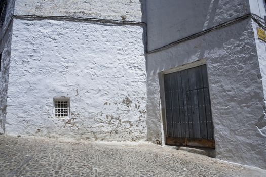 Corner of Sabiote with a wooden door and little window, Jaen province, Andalusia, Spain