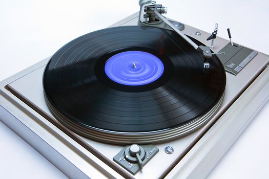 Vintage record player with spinning vinyl. 