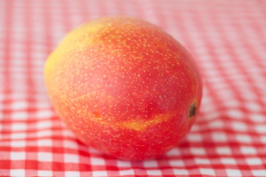 mango fruit on checkered fabric