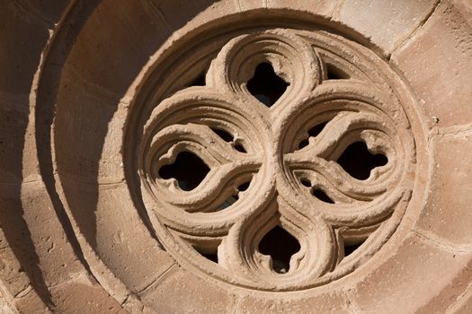 Occulus gothic. Details of the front of the side entry of the Church of Santa Maria, Linares, Jaen province, Andalusia, Spain
