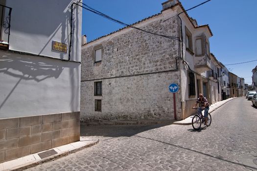 Biker on the road in Sabiote, Jaen province, Andalusia, Spain