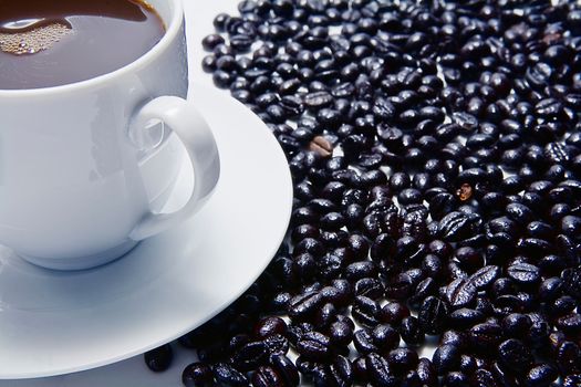 Traditional cup of coffee and coffee beans roasted