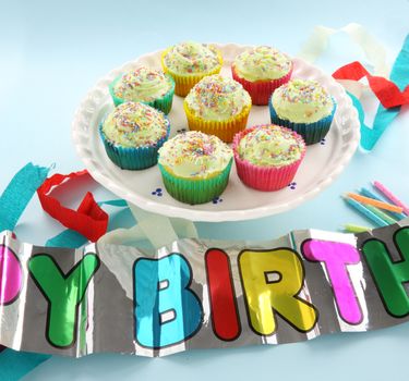A plate of delicious iced cup cakes for a birthday celebration.