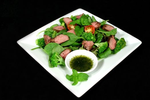 Delicious cold lamb salad with mint sauce.