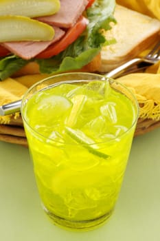 Thirst quenching iced lemon and lime drink with fruit pieces.
