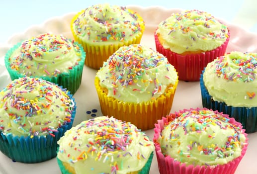 A plate of delicious iced cup cakes ready to serve.
