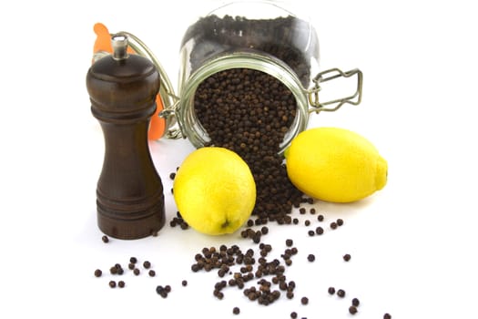 Two lemons and pepper corns with a grinder.