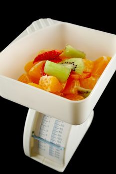 Set of kitchen scales weighing fresh fruit.