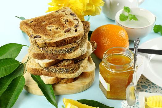 Homemade orange marmalade jam with toast and fresh orange.